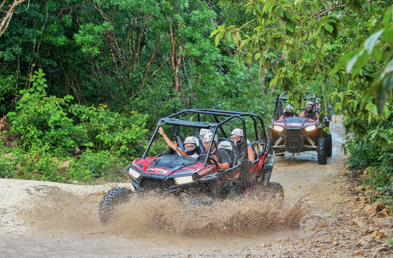 Group of people enjoying off roading in the mud