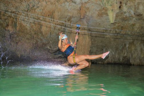 woman on a zip line in a cave