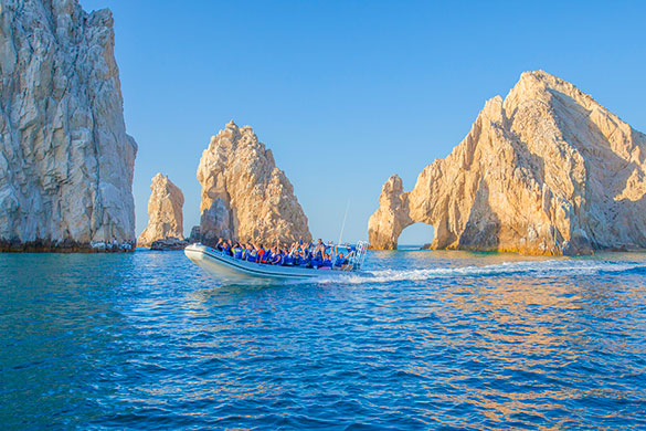 Speedboat with a group of people in front of Land’s End Arch during our Cabo San Lucas Snorkeling Adventure tour.