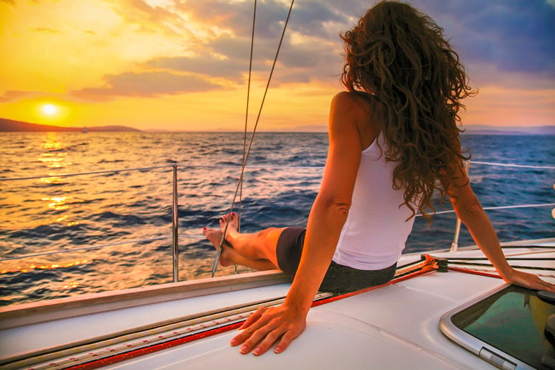 woman watching cabo sunset on luxury sailing tour
