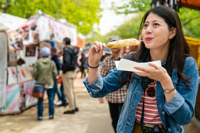 Woman eating Mexican Elotes