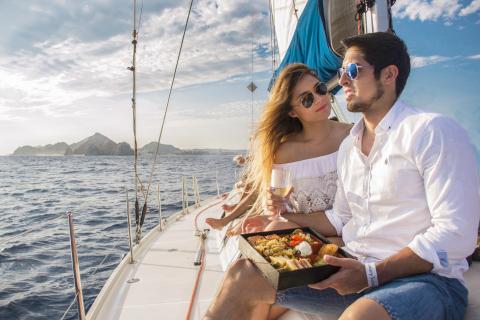 couple on a sail boat eating a meal