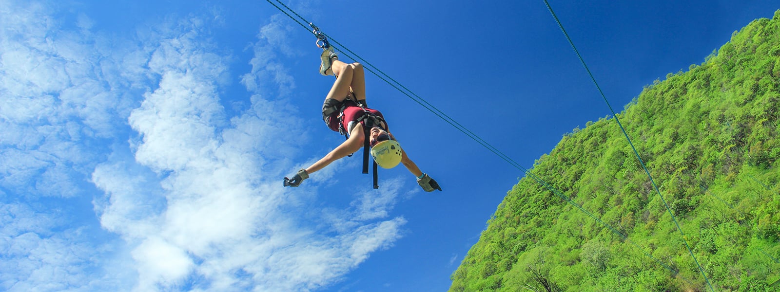 woman upside down on zipline tour in cabo