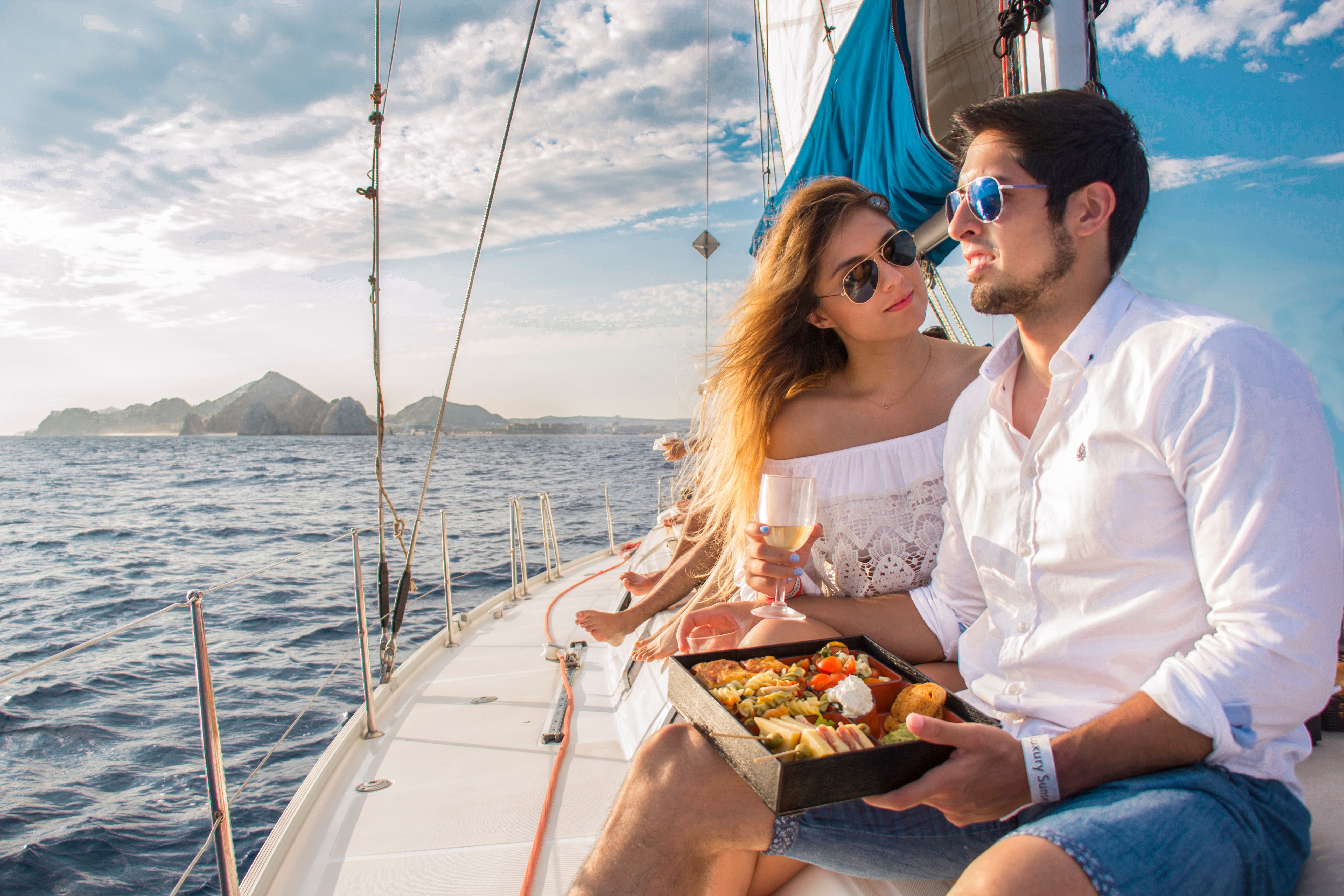 A couple enjoying lunch while on a luxury sunset sailing tour