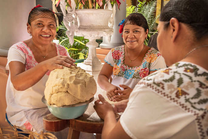Traditional Mexican food being made by 3 women