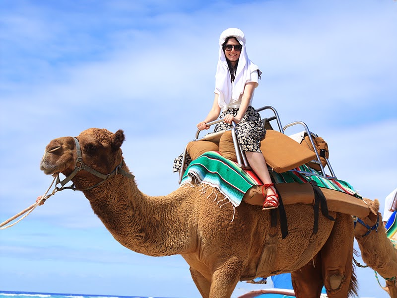 Woman riding a camel