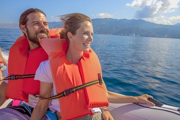 Couple smiling on speedboat during Vallarta Adventures Sea Safari tour