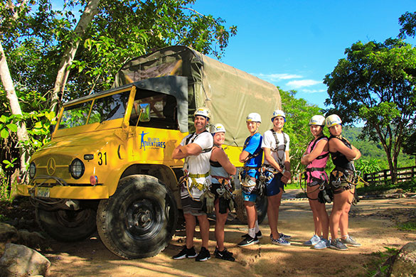 Small group posing in front of Vallarta Adventures’ truck during the outdoor zipline adventure tour