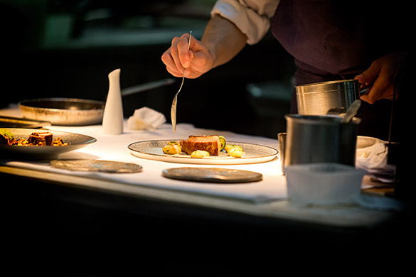 Chef adding final touches to fine dining meal