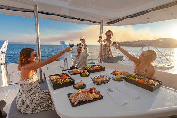 Group saying cheers while on a private sunset sailing excursion