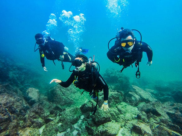 Scuba divers underwater during our small group scuba diving trip