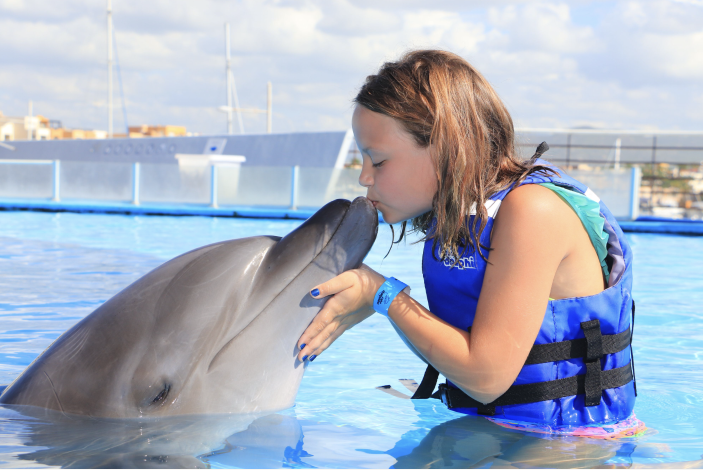 girl in a close encounter with a dolphin in Cabo
