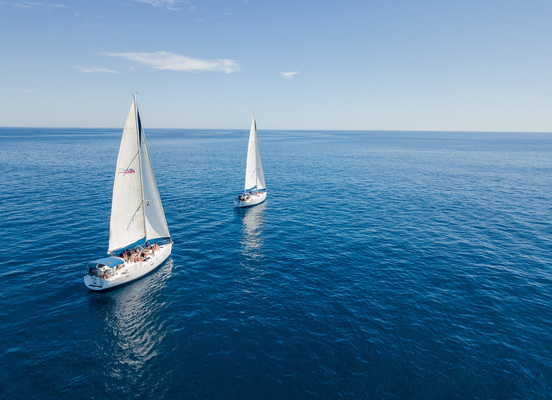 2 luxury sail boats sailing in ocean near cabo mexico