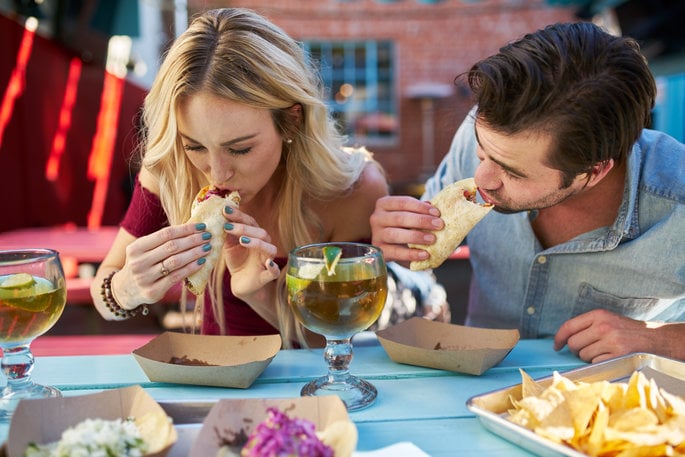 Couple eating tacos together