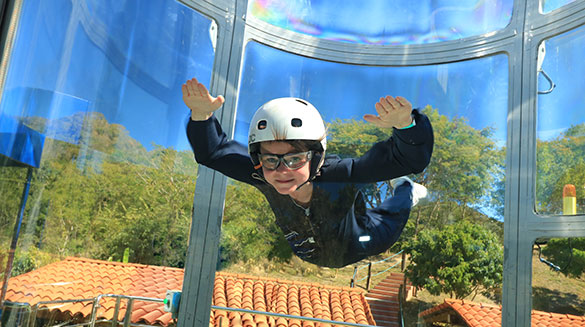 Young boy indoor skydiving on our Extreme Zip Line Adventure excursion