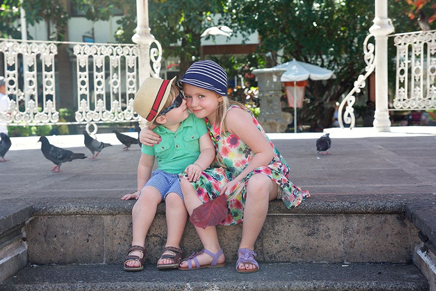 Two kids sitting on steps in Puerto Vallarta