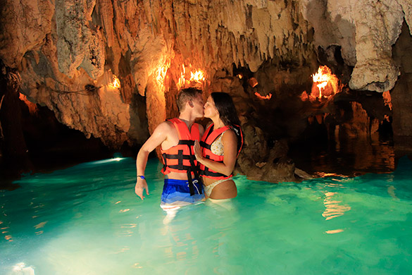 Couple kissing in a cenote in Cancun