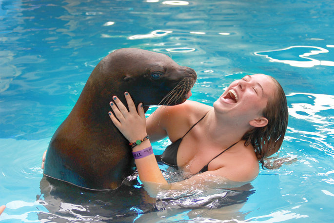 woman enjoying an encounter with a sea lion