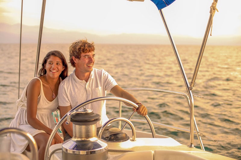 Couple enjoying sunset sailing trip with Cabo Adventures during their honeymoon