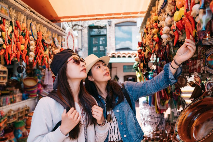 Tourists looking at peppers in Mexican market