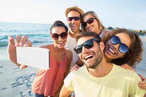 Group of friends taking a selfie on the beach