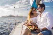 couple on a sail boat eating a meal
