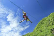 woman upside down on zip line in cabo mexico