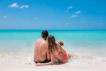 Couple enjoying a drink on the beach