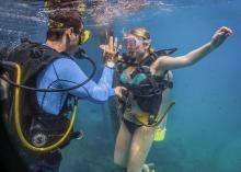 Scuba diver instructor and scuba diving student underwater